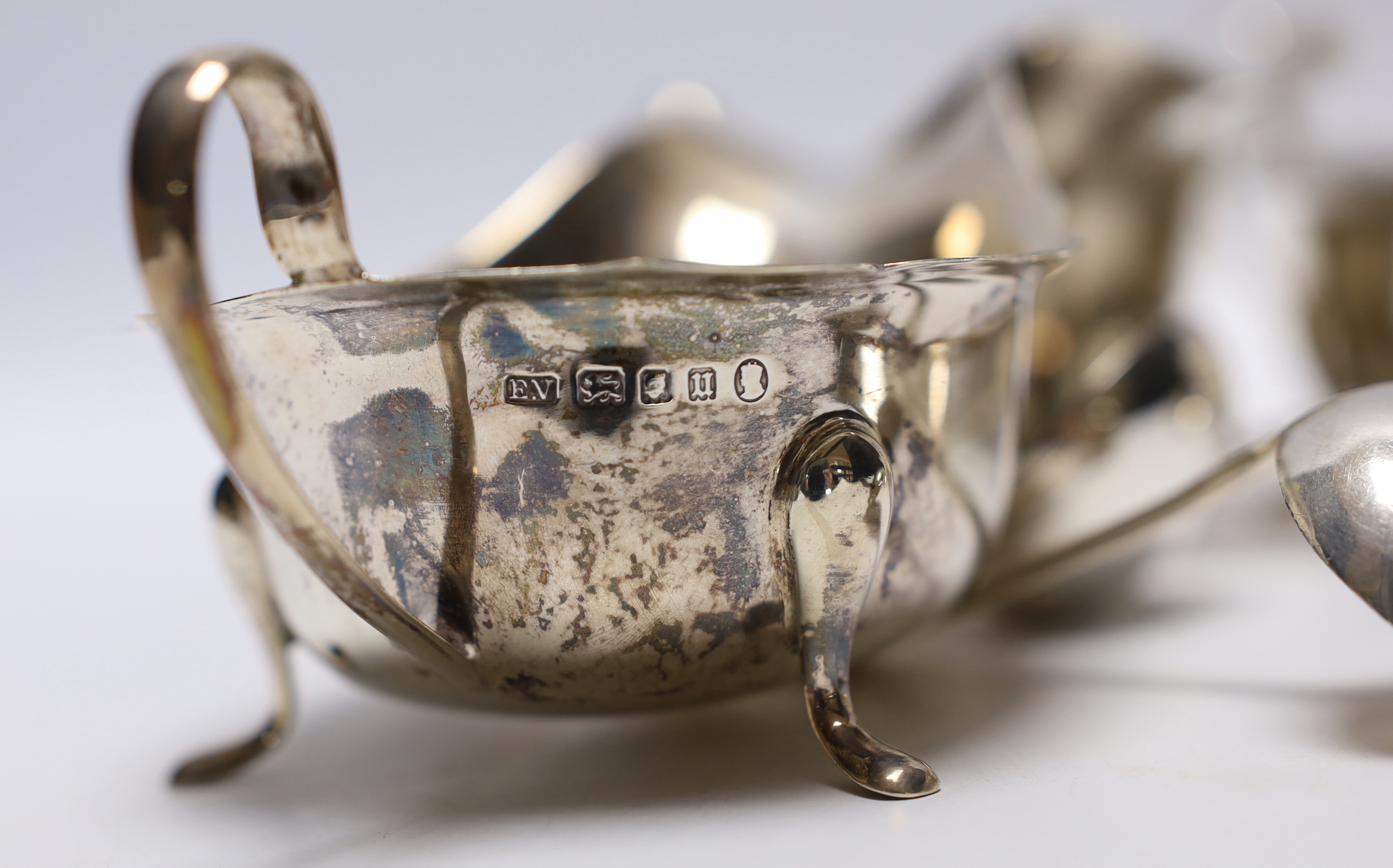 A set of three George VI silver sauceboats, Viners Ltd, Sheffield, 1937, together with three ladles (two silver) and one other silver sauceboat, 16.1oz.